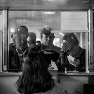 Black and white photo of people at a ticket counter in Ankara, Türkiye.